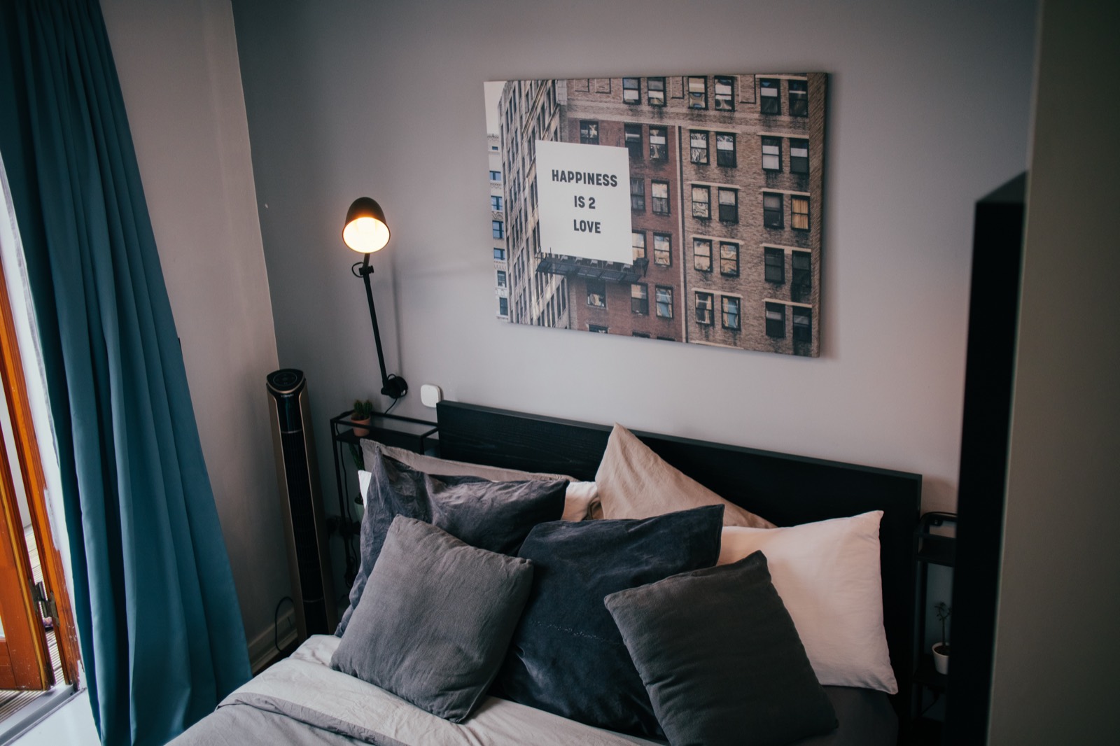 Bedroom with desk, lamp and wall art