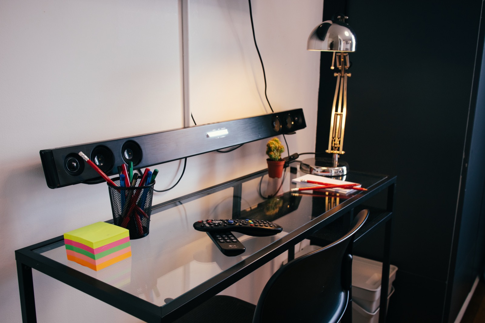 Desk with lamp, pens and notes for guests